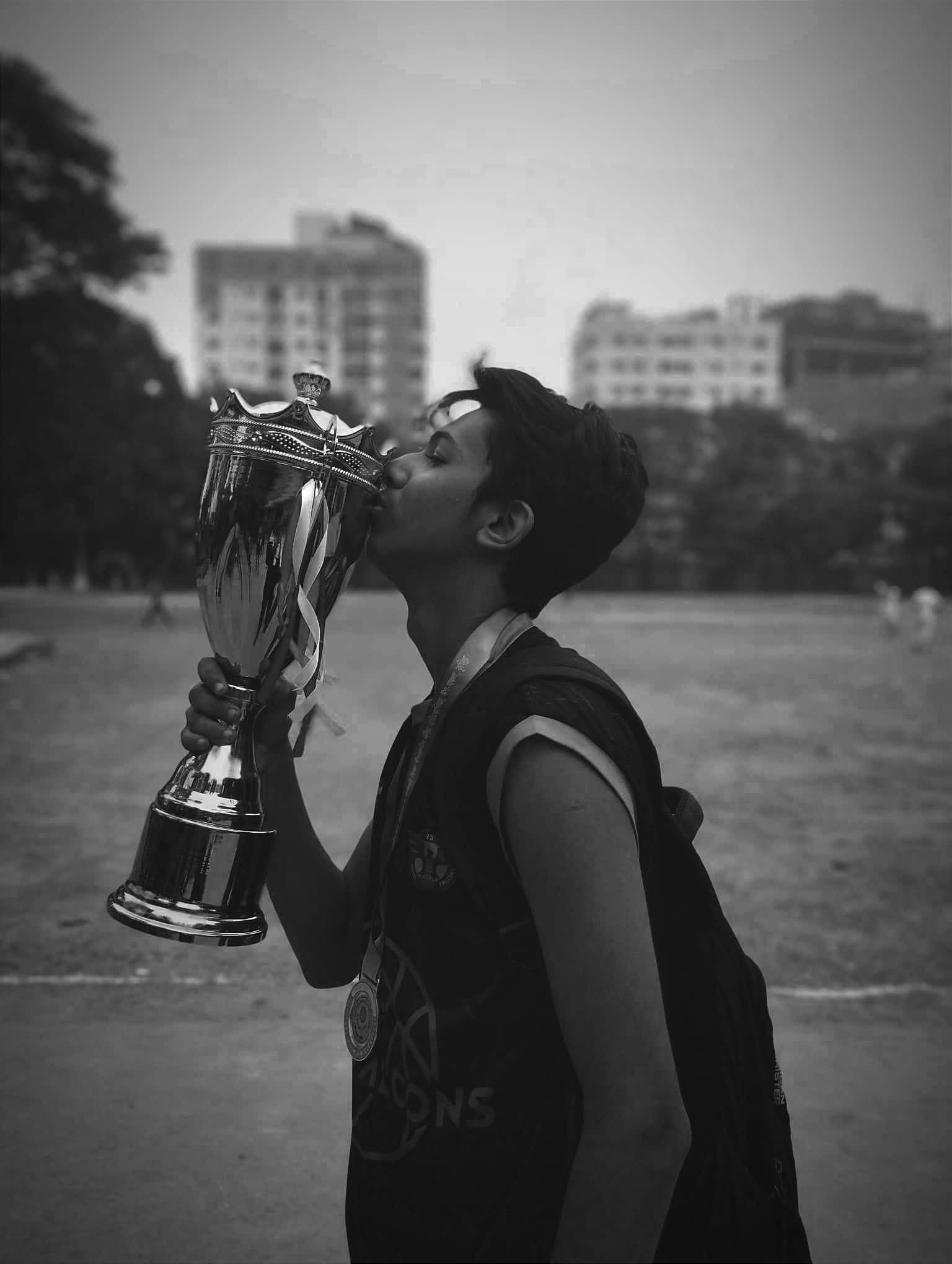 Kissing the Basketball Championship Trophy